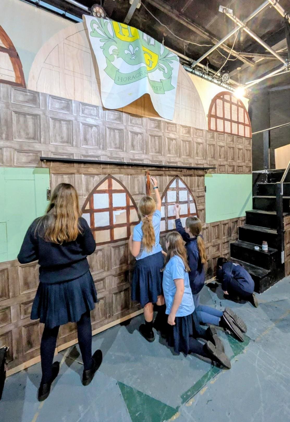 Art students at Windermere School played a vital role in bringing the School of Rock production to life, working behind the scenes to transform creative ideas into vibrant stage magic. From wallpaper-pasting, to painting large-scale banners and crafting the detailed set, their efforts could be spotted in every corner of the stage in Crampton. The production was a fantastic collaboration between Drama, Music, and Art—to create a show that truly rocked.